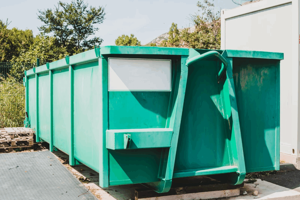 Large green waste container at a local sorting station