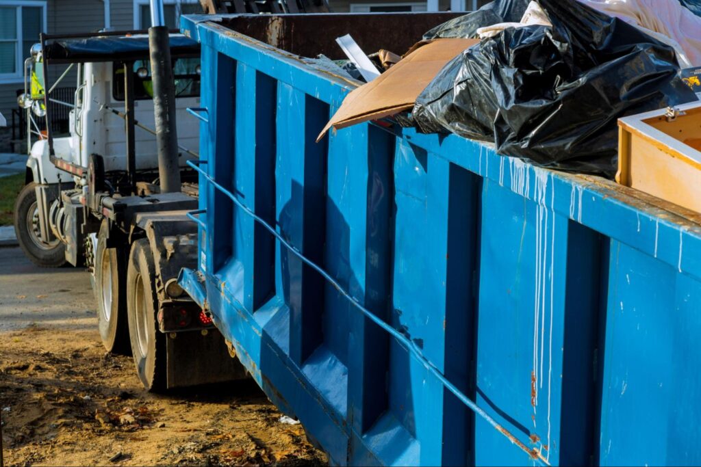 Dumpster on the back of a truck.